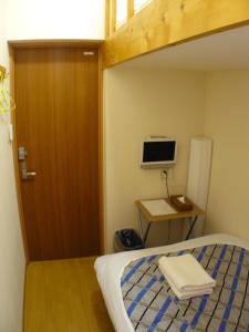 Tempat tidur dalam kamar di Hotel Meigetsu