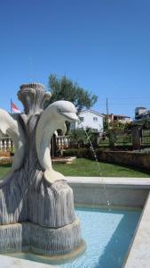 a fountain with two pigeons drinking water from it at Apartments Lean in Poreč