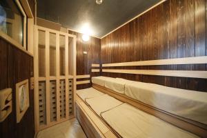 a wooden cabin with two beds in it at Dormy Inn Miyazaki Natural Hot Spring in Miyazaki