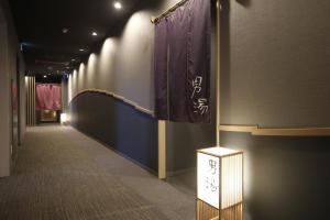 a hallway with a flag and a sign on a wall at Dormy Inn Miyazaki Natural Hot Spring in Miyazaki