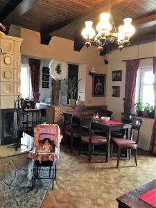 a living room with a table and a dining room at Penzión Villa Mon Ami in Smokovce