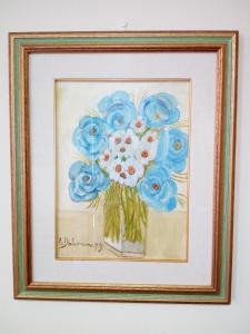 a painting of blue flowers in a vase at BB Mambrotta in San Martino Buon Albergo