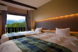 Ένα ή περισσότερα κρεβάτια σε δωμάτιο στο Hotel Hakuba Berghaus