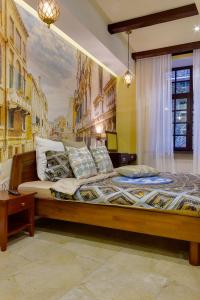 a bedroom with a bed with a painting on the wall at Apartment City in Saint Petersburg