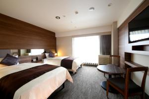 Postel nebo postele na pokoji v ubytování The Hedistar Hotel Narita