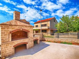 a brick oven in front of a house at Apartments Medulin 396 in Medulin