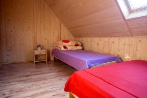 a bedroom with two beds in a wooden cabin at Ośrodek Wczasowy Maliwa in Jarosławiec