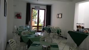 a dining room table with chairs and tables at La Zagara Hotel in Canneto