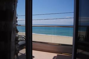 a view of the beach from a window at Terra Kotta in Paralia Vrachou
