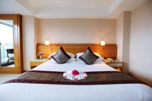 Voodi või voodid majutusasutuse Yihe Hotel Ouzhuang toas