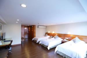 Voodi või voodid majutusasutuse Yihe Hotel Ouzhuang toas