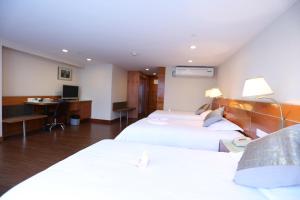 Voodi või voodid majutusasutuse Yihe Hotel Ouzhuang toas