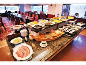 a buffet of food on a table in a restaurant at Hotel Global View Kushiro in Kushiro