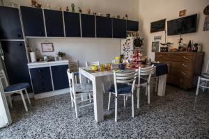 a kitchen with a table and chairs in a room at Miky M House B&B in Cagliari