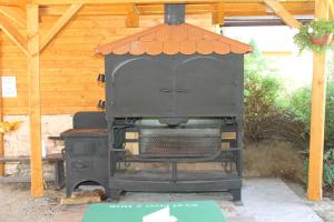 an outdoor grill in a pavilion with at Penzion Rollba in Loučná nad Desnou