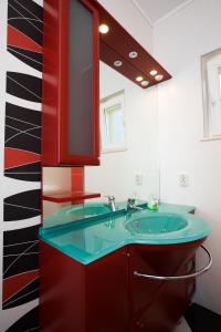 a bathroom with a green sink and a mirror at Apartments Silence in Mlini +95 photos
