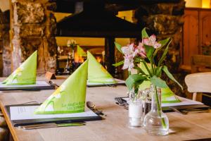 a table with green paper boats on top of it at The Saracens Head Inn in Symonds Yat