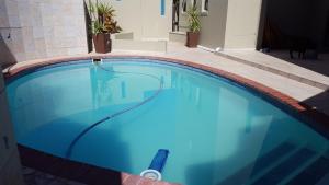 a swimming pool with a hose in a house at The Port Owen Holiday House in Velddrif