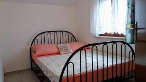 a bedroom with a bed with orange pillows on it at Apartments Dada in Vir