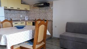 a kitchen with a table with a bowl on it at Apartments Dada in Vir +28 photos