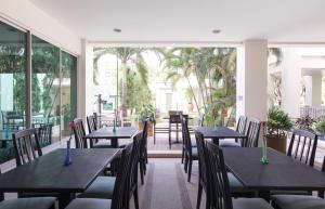 a row of tables and chairs in a restaurant at Somerset Vientiane in Vientiane