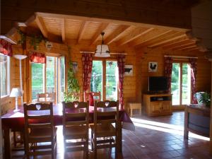 a dining room with a table and chairs in a cabin at Le Chalet de Philippe in La Bresse