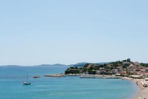 a view of a beach with a boat in the water at Hotel Korakakis Beach in Finikounta
