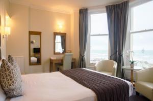 a hotel room with two beds and a window at Kings Hotel in Brighton & Hove