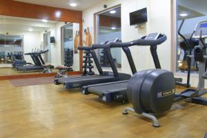 a gym with several tread machines in a room at Pratap Mahal Pushkar IHCL SeleQtion in Pushkar