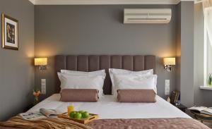 a bed with a tray of fruit on top of it at Easy Room in Nizhny Novgorod