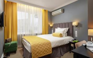 a hotel room with a large bed and a window at Easy Room in Nizhny Novgorod