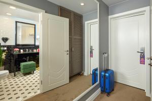 two suitcases are standing in a bathroom with a toilet at Easy Room in Nizhny Novgorod