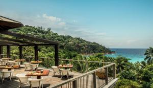 a restaurant with a view of the ocean at Four Seasons Resort Seychelles in Baie Lazare Mahé