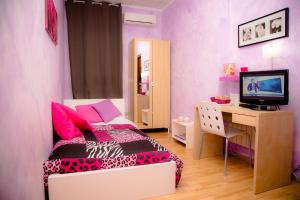 a bedroom with a bed and a desk with a computer at Residenza Campus Roma in Selcetta