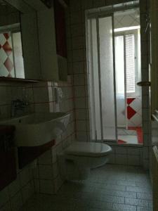 a bathroom with a sink and a toilet and a window at Apartment Zupan in Maribor
