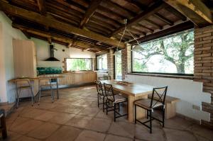 a kitchen with a table and chairs in a room at Borgo Santa Cristina in Castel Giorgio