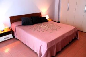 a bedroom with a large bed with a pink blanket at Rubino in Gallipoli