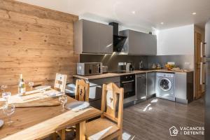 a kitchen with a table and a dining room at Nazca C8 in Val Thorens +7 photos