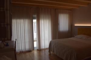 Ένα ή περισσότερα κρεβάτια σε δωμάτιο στο Residenza Ai Capitelli