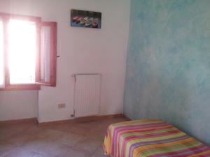 a white room with a bed and a window at Alloggio Lavanda in Diano San Pietro