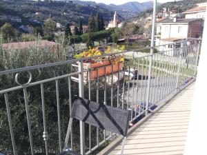 a balcony with a pot of flowers on it at Alloggio Lavanda in Diano San Pietro +6 photos