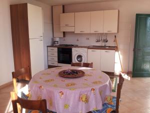 a kitchen with a table with a plate on it at Alloggio Lavanda in Diano San Pietro