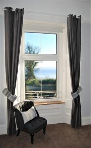 a window with a chair in front of a window at Kingswood Hotel in Burntisland