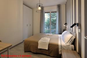 a bedroom with a bed with two towels on it at Casa Rimidia FLAT GIOVANNA in Perugia +12 photos