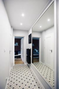 a hallway with a large mirror on the wall at Apartament Kowalska in Gdańsk