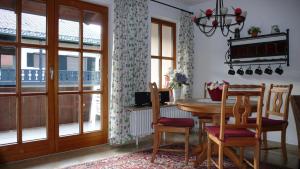 a dining room with a table and chairs and a window at Apartment Jasmin in Garmisch-Partenkirchen