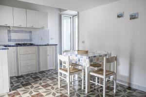 a kitchen with a table and chairs in a room at Salvatore 6 in Ponza