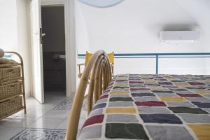 a bedroom with a bed with a colorful quilt at Salvatore 6 in Ponza