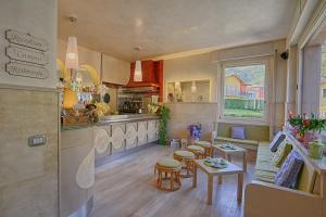 a kitchen with a table and some chairs in a room at Hotel Europa - Sorico in Sorico