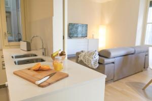 a kitchen counter with a cutting board with oranges on it at Bravissimo Cort Reial-3B in Girona